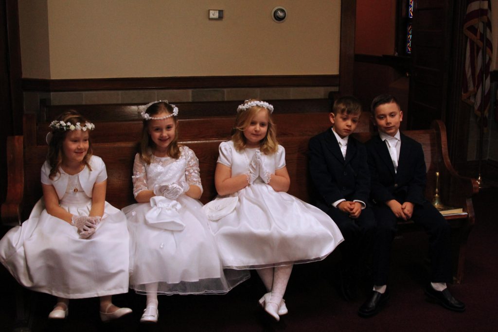 First Communion Children wait for start of Mass