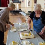 Kathy and Laura cutting cake
